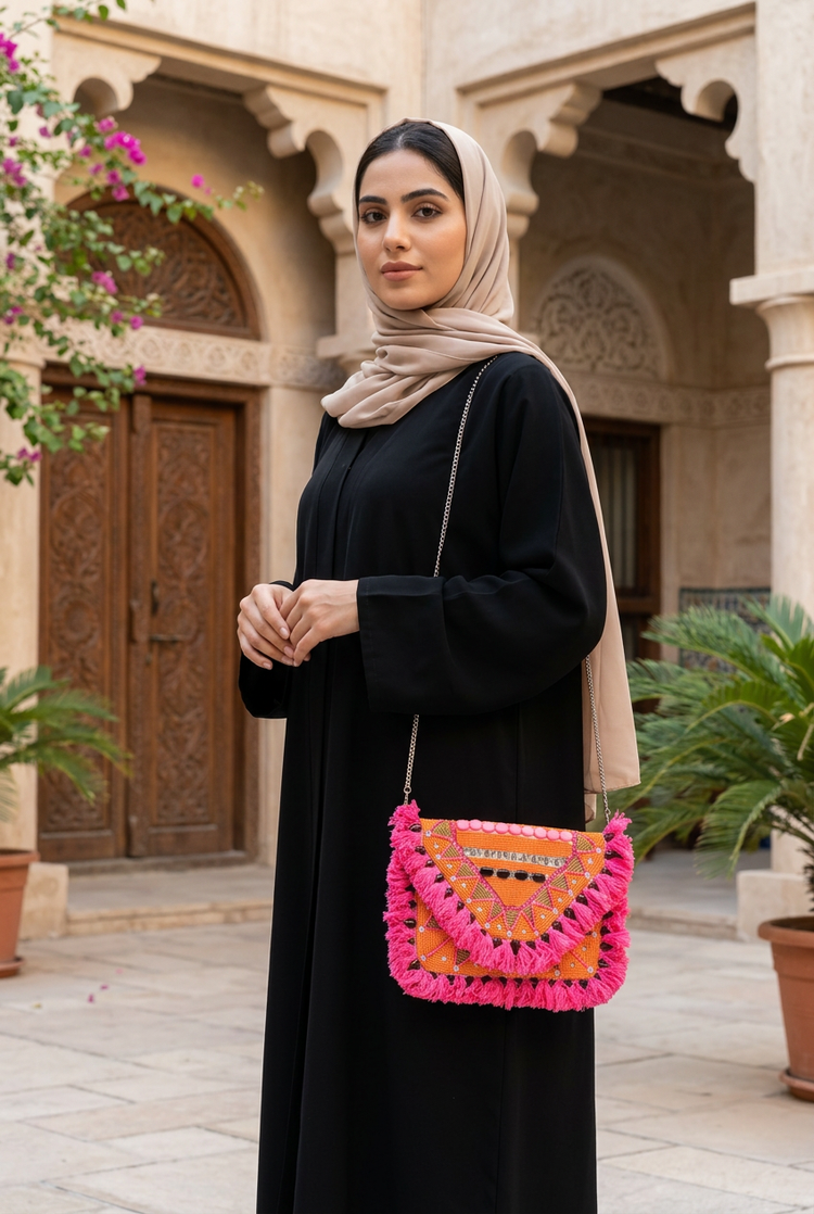 Mango Fiesta orange and pink bag styled with black abaya