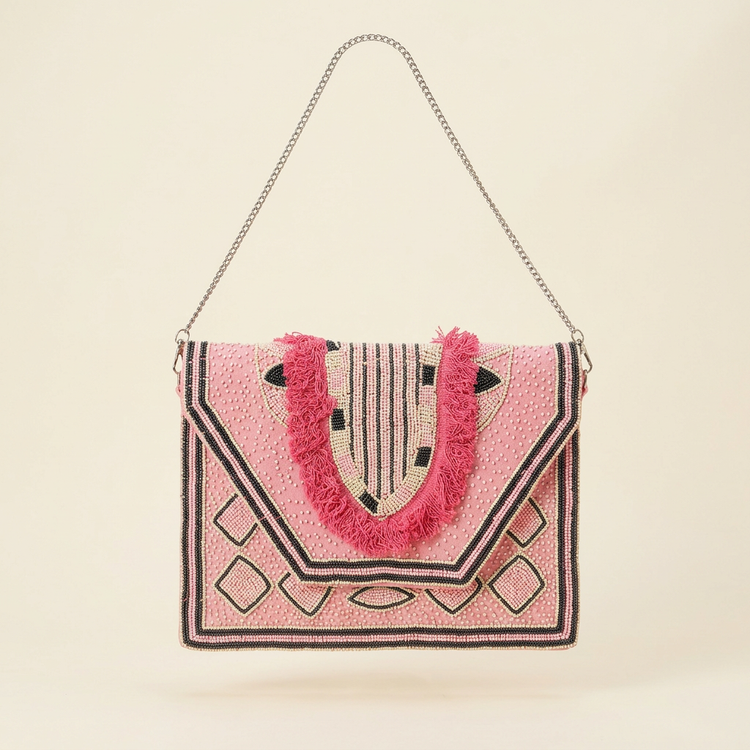 Amara pink geometric fringe bag on cream studio background