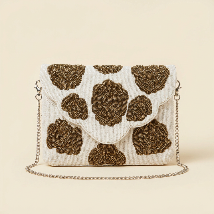 Rosette ivory and bronze floral bag on cream studio background