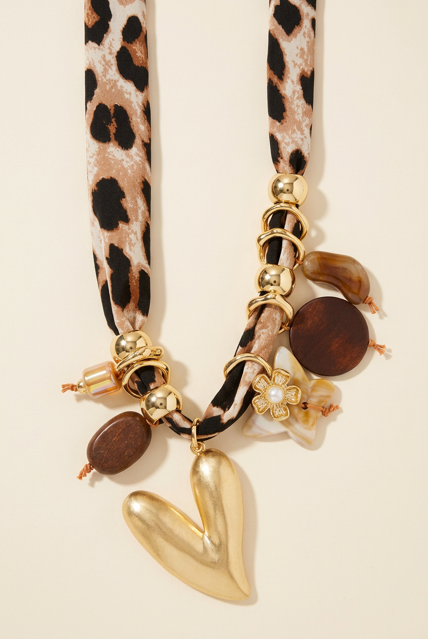 Corrected leopard scarf and gold heart charm necklace on cream, without extra fabric loop or bow