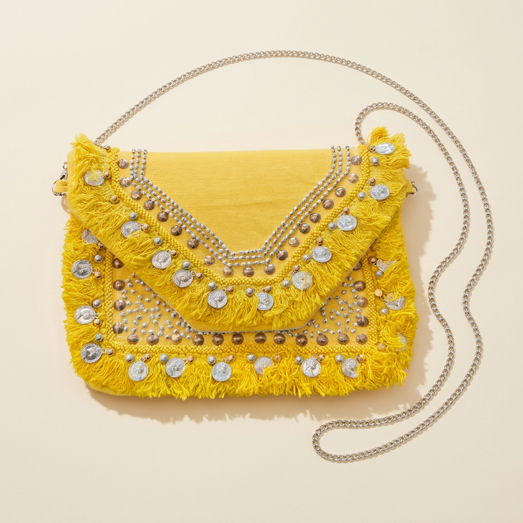 Yellow coin and fringe boho clutch with silver chain, studio image