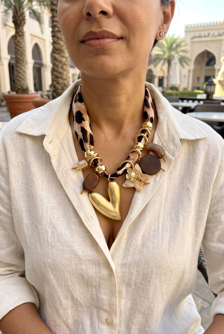 Medium-size leopard scarf and gold heart necklace worn with ivory linen