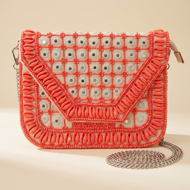 Coral shell and mirror beaded clutch with silver chain, studio image