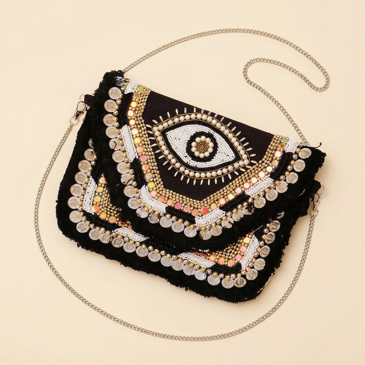 Nazar black eye-motif bag on cream studio background