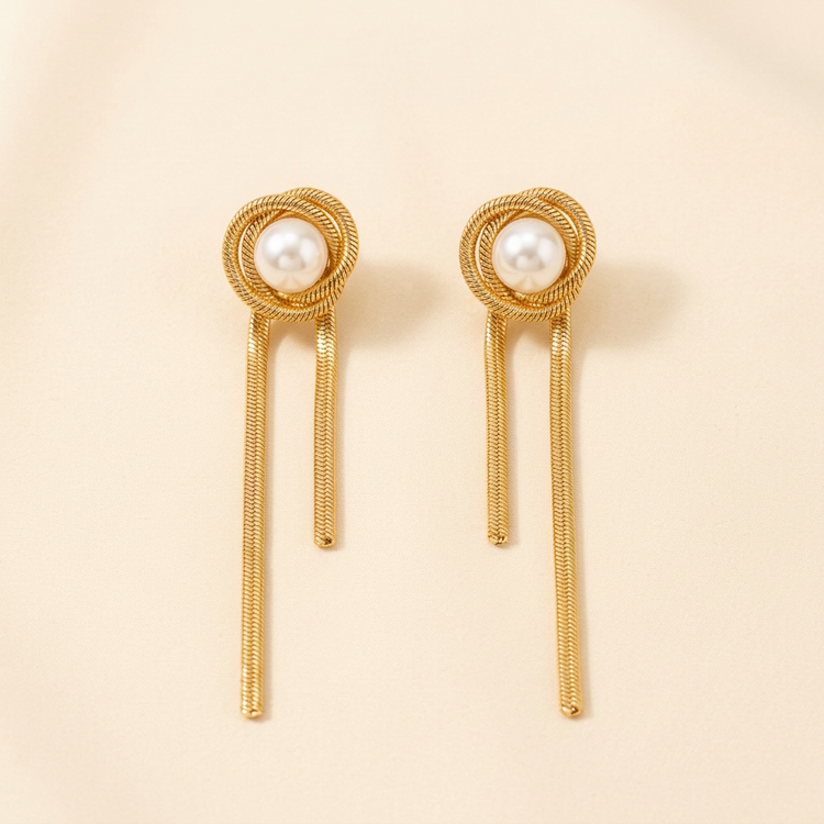 Pearl Knot Gold Snake Chain Earrings studio shot on cream
