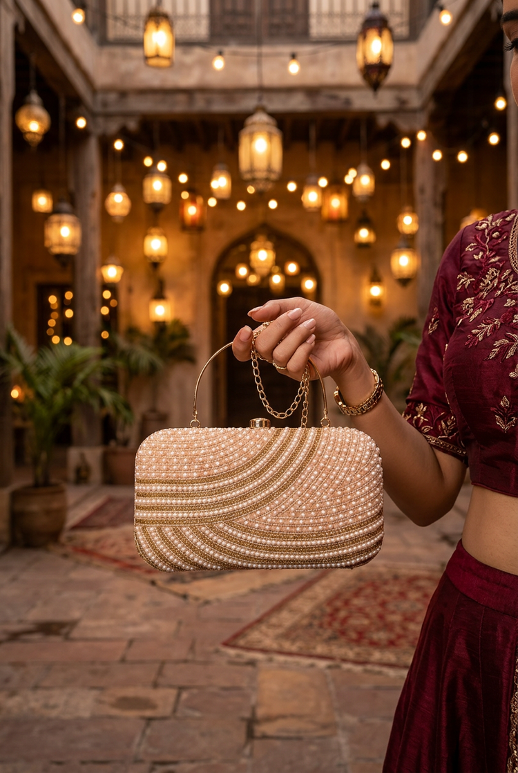 Satin Current Beige wave beaded clutch at a festive celebration