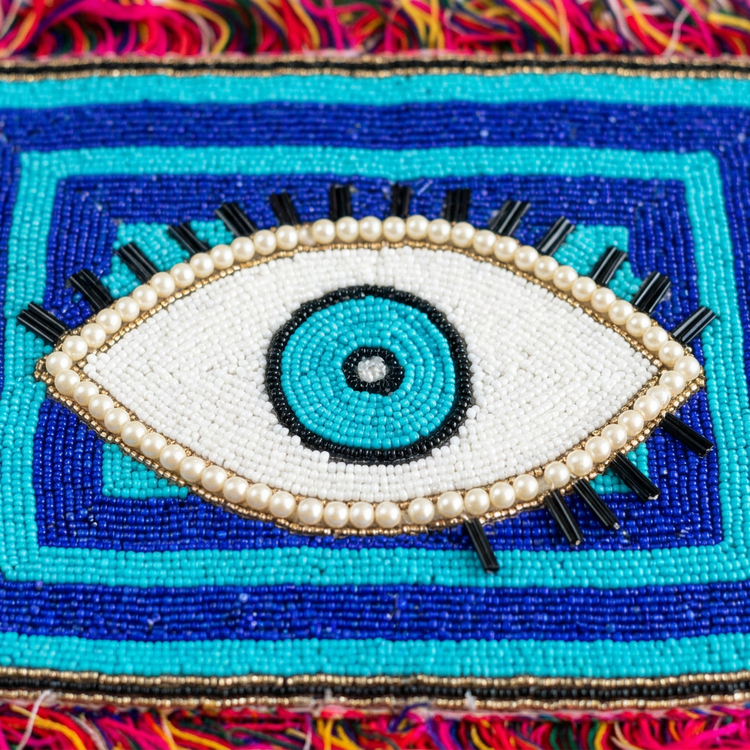 Blue eye beadwork and colourful fringe, AI-generated detail image