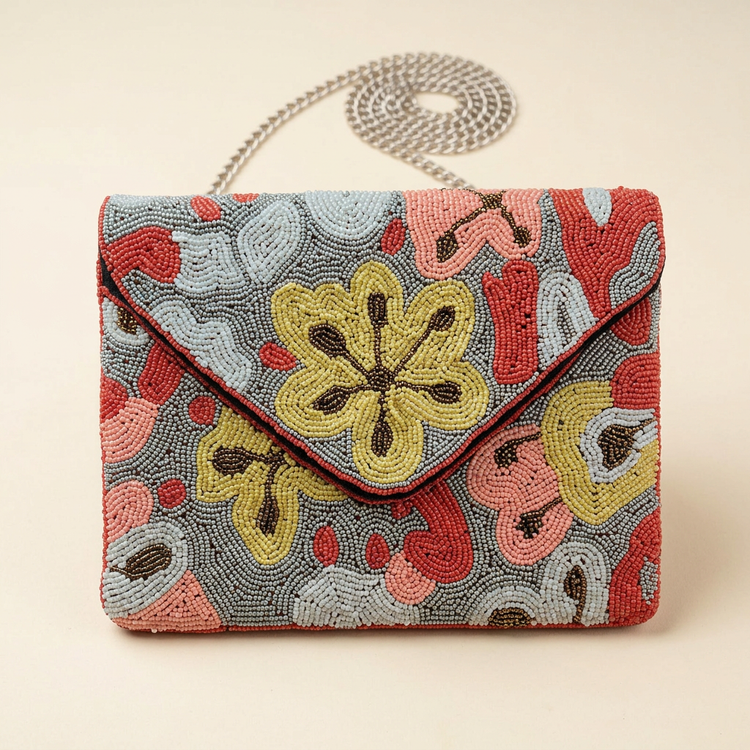 Poppy floral beaded bag on cream studio background