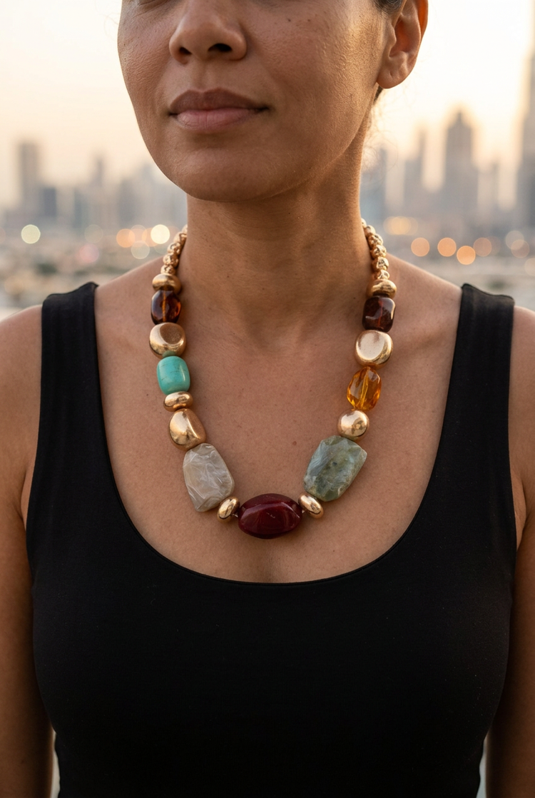 Medium-size multicolour faceted bead necklace worn with a black neckline