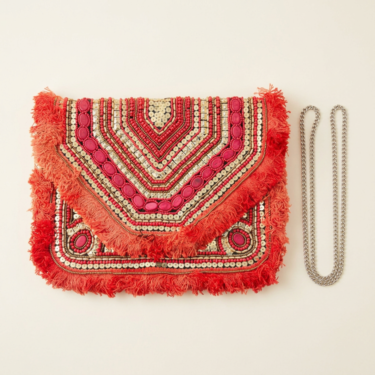 Coral red beaded chevron fringe clutch, AI-generated studio image