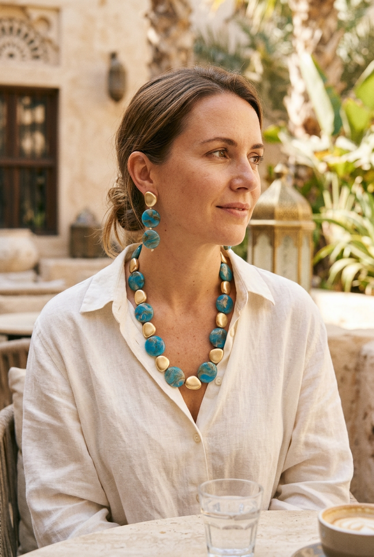 Medium-size blue marbled necklace and earrings set worn with ivory linen