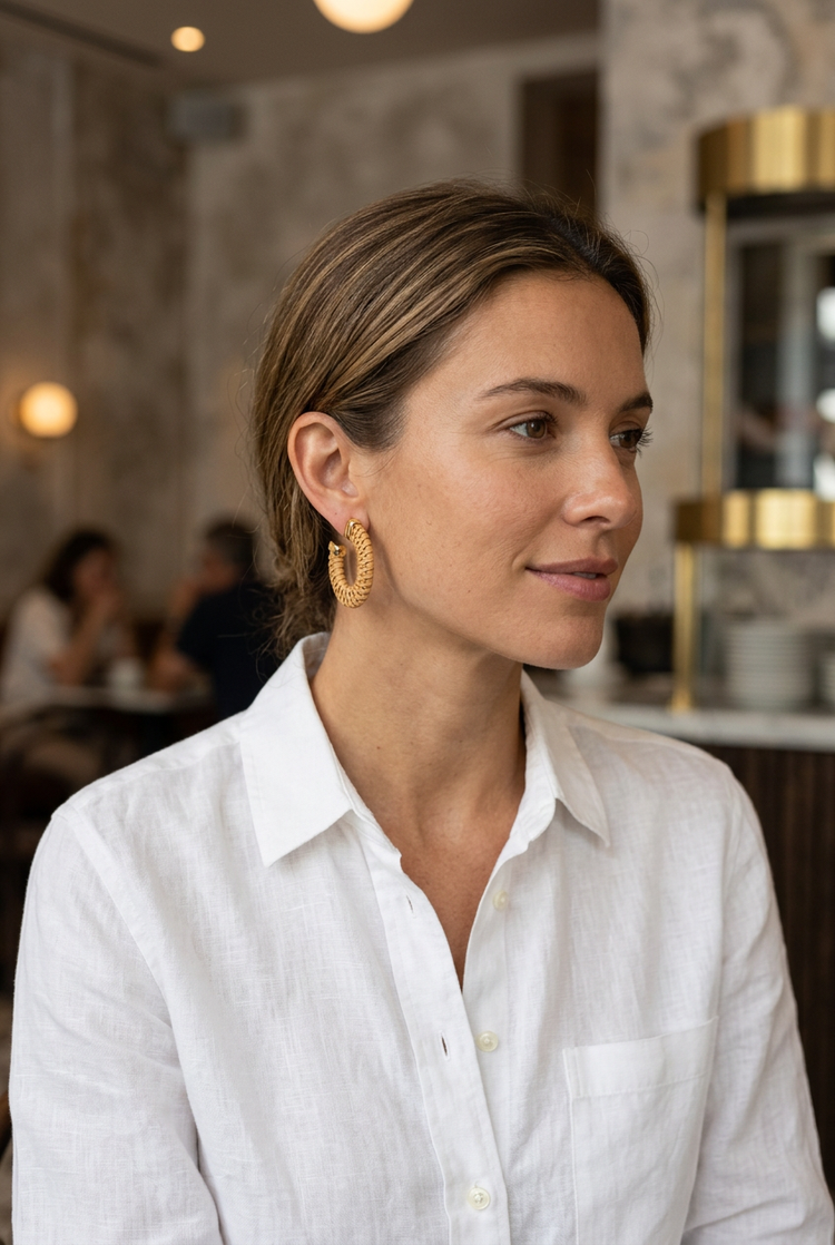 Natural woven hoop earrings worn with a white linen shirt