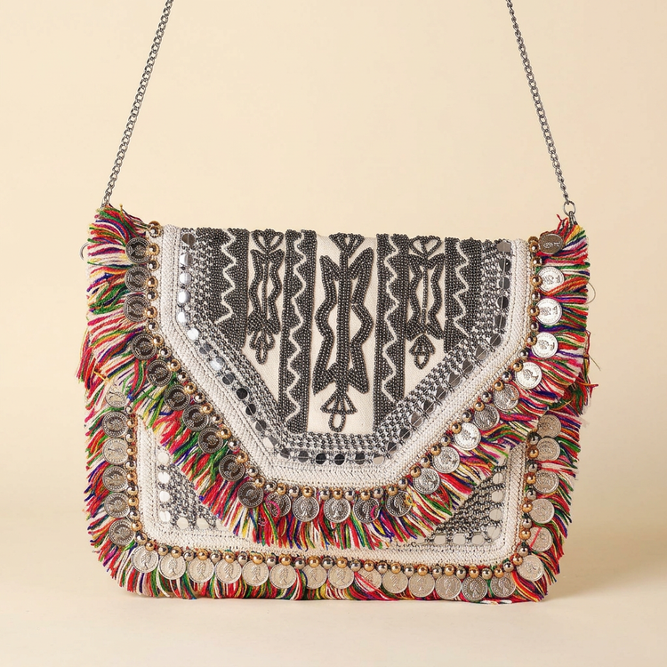 Sahara coin and fringe boho bag on cream studio background