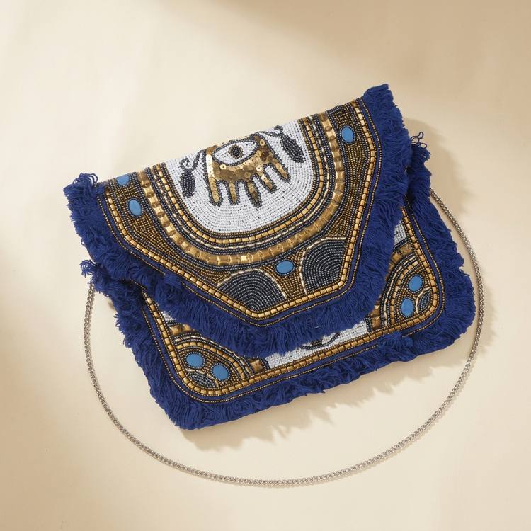 Blue Oracle navy eye-motif bag on cream studio background