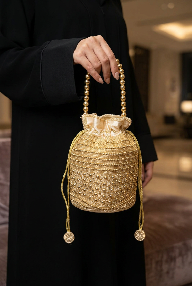 Golden Halo gold beaded potli styled with an abaya