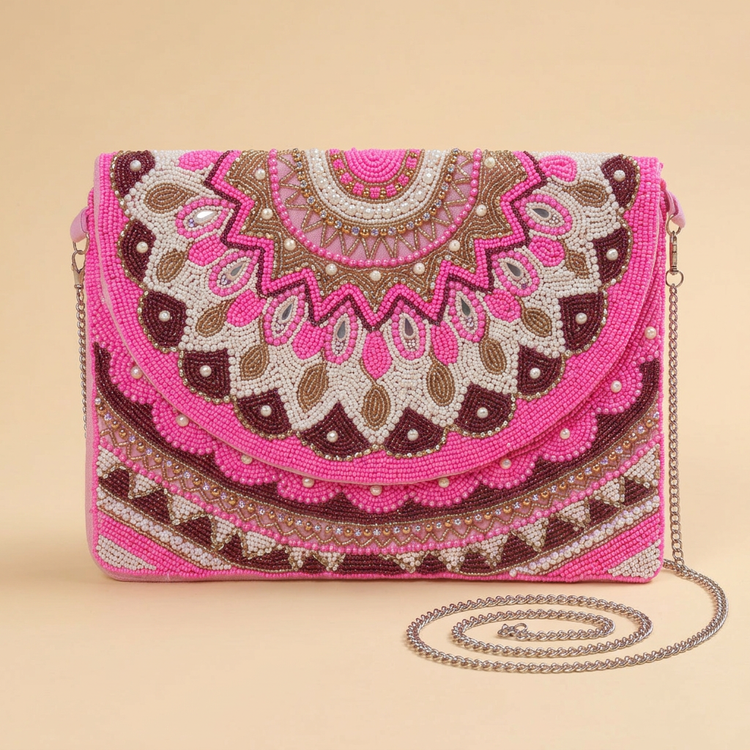 Zahra pink beaded bag on a cream studio background
