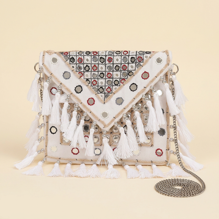 Ivory Muse mirror and white tassel bag with silver chain on cream studio background