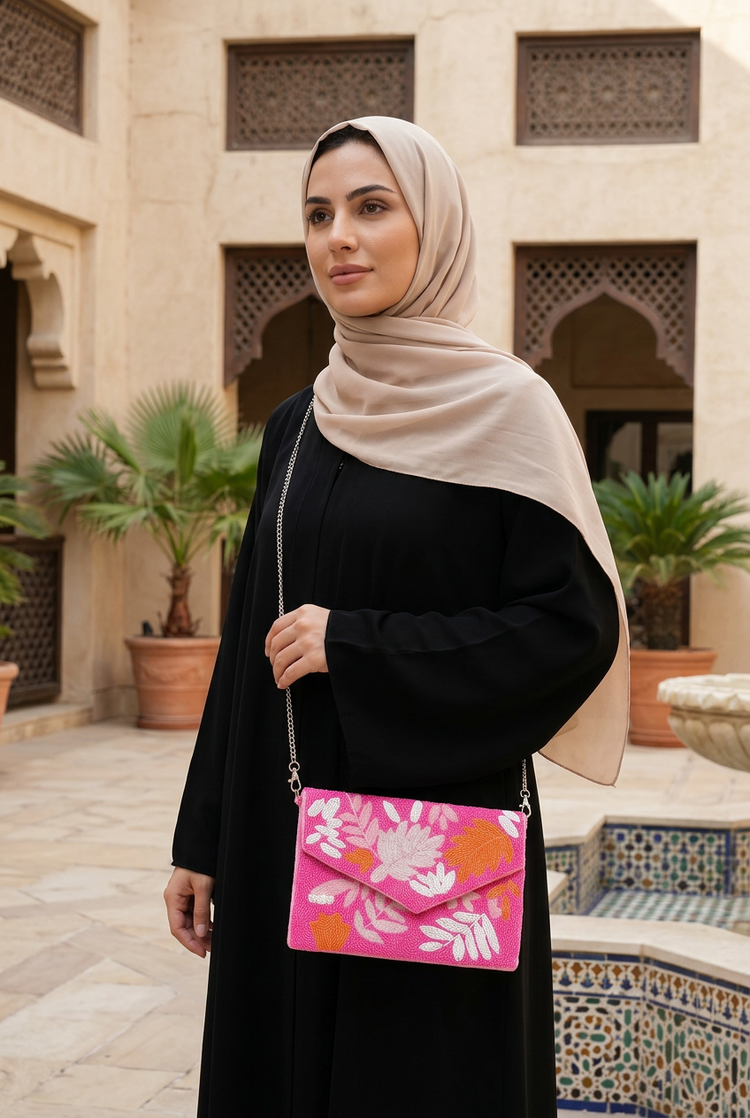Pink Tropic botanical bag styled with black abaya