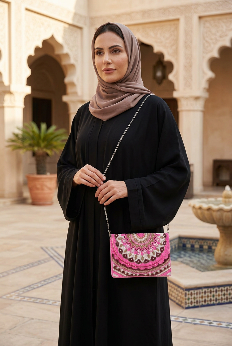 Zahra pink bag styled with a black abaya and taupe shayla
