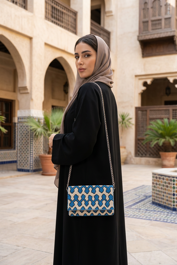 Azura blue geometric bag styled with black abaya