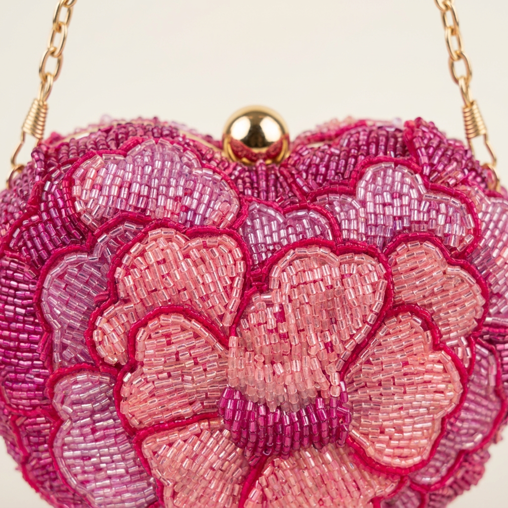 Close-up of layered pink floral beadwork and gold-tone clasp