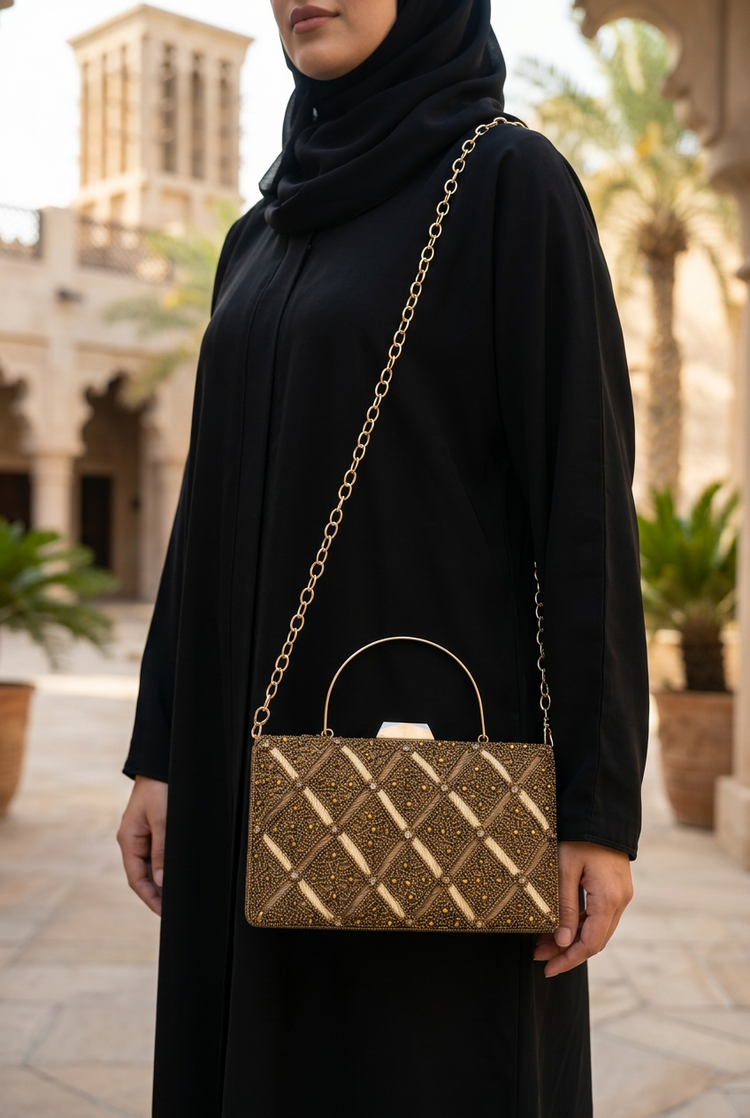 Bronze Quadrant sling bag worn with black abaya