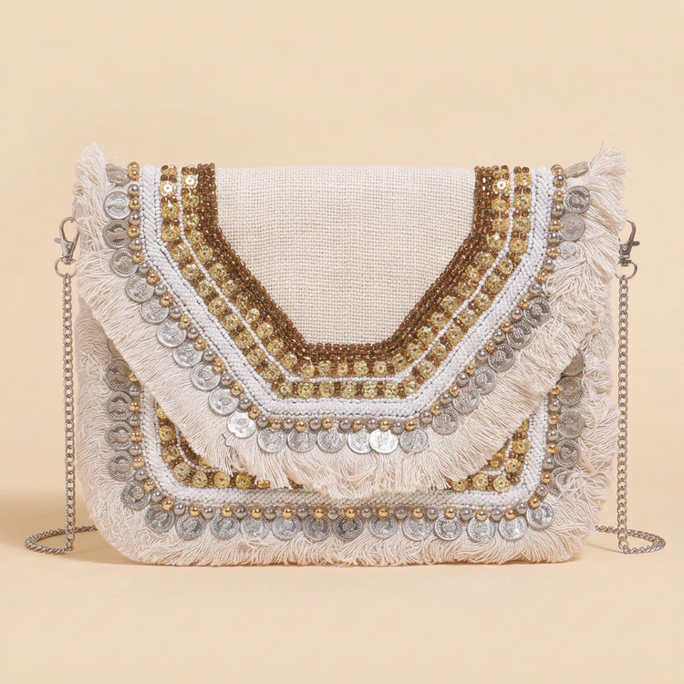 Ivory Glow beaded coin and fringe bag on cream studio background