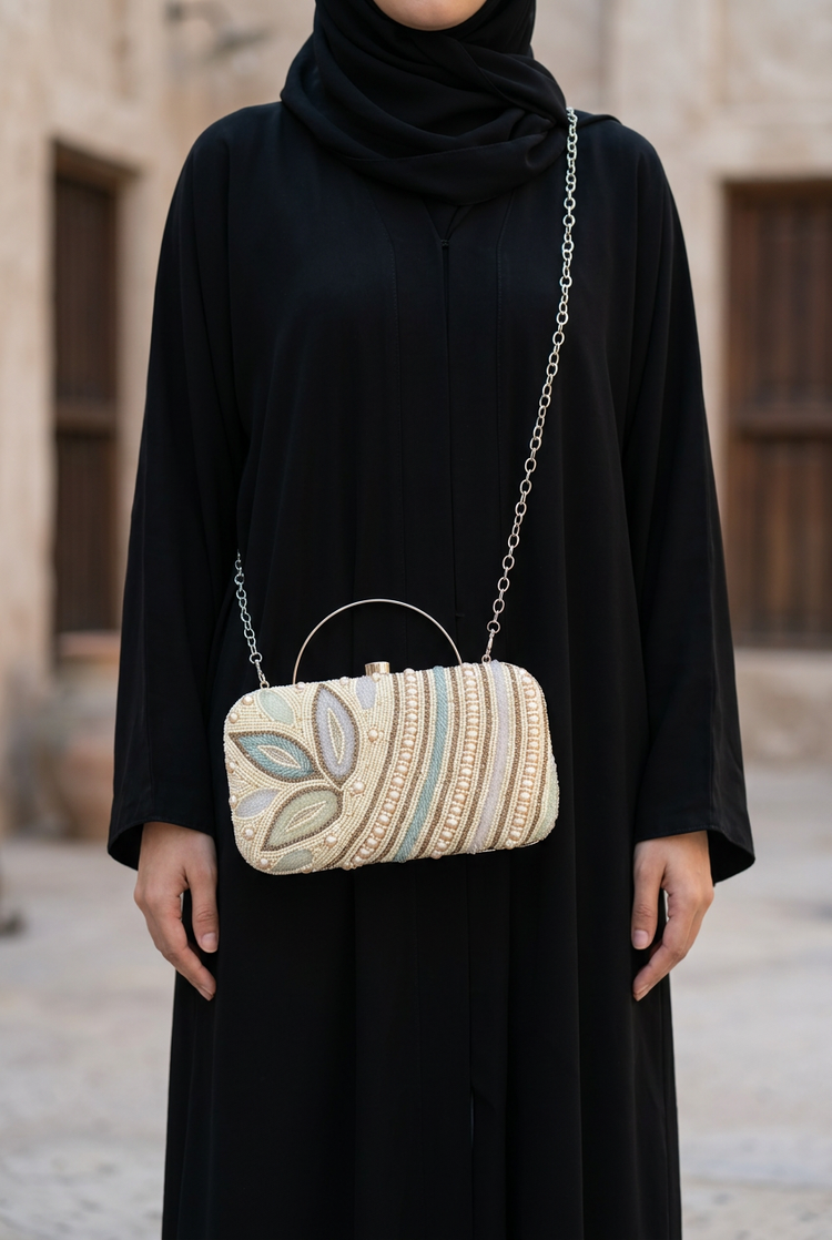 Pearl Botanica sling bag worn with black abaya