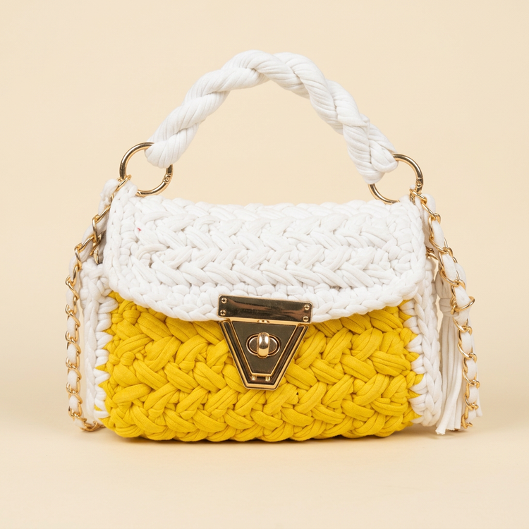 Sunshine yellow crochet top-handle bag on a cream studio background
