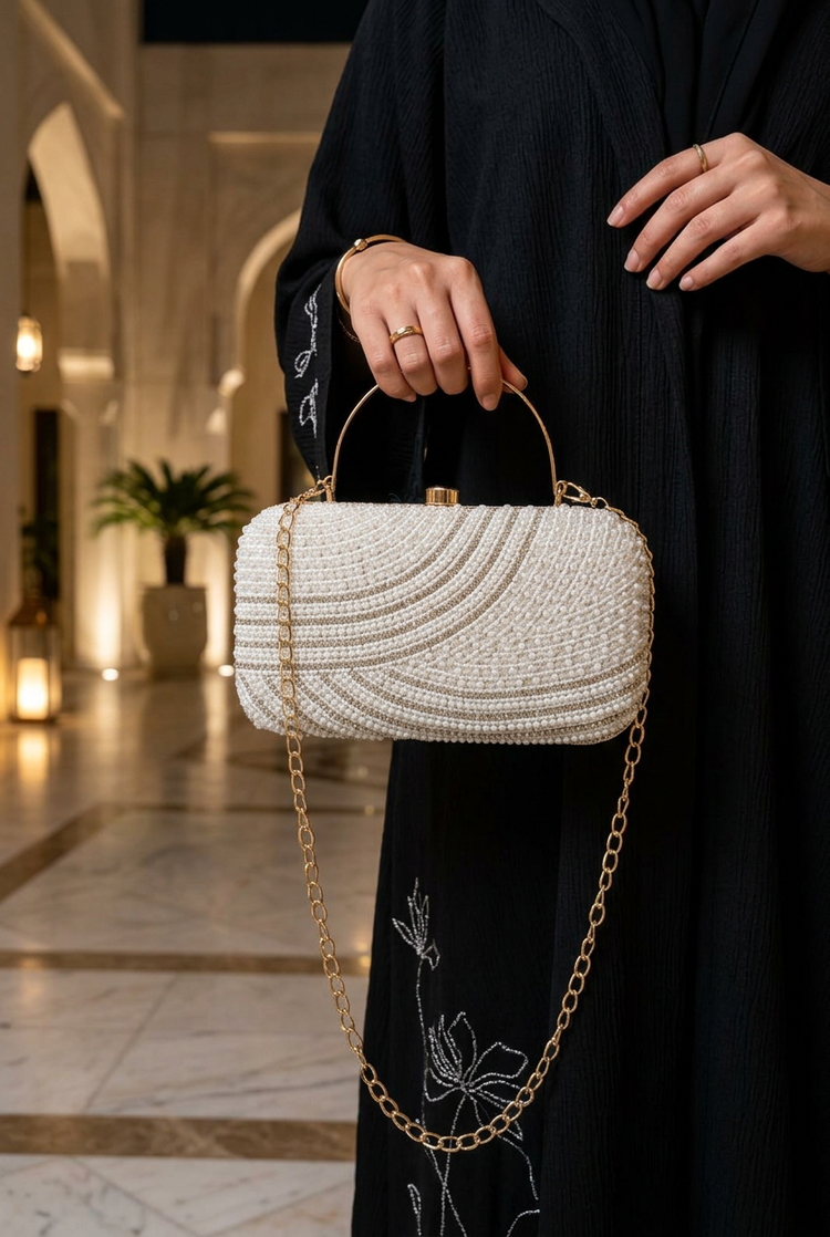 Satin Current Silver wave beaded clutch styled with an abaya