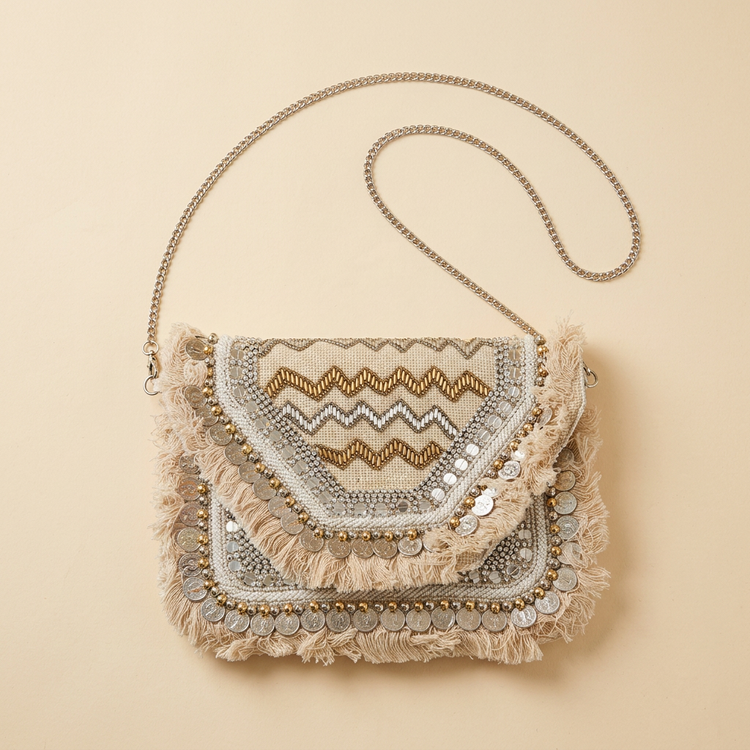 Ivory metallic zigzag fringe clutch with long silver chain, studio image