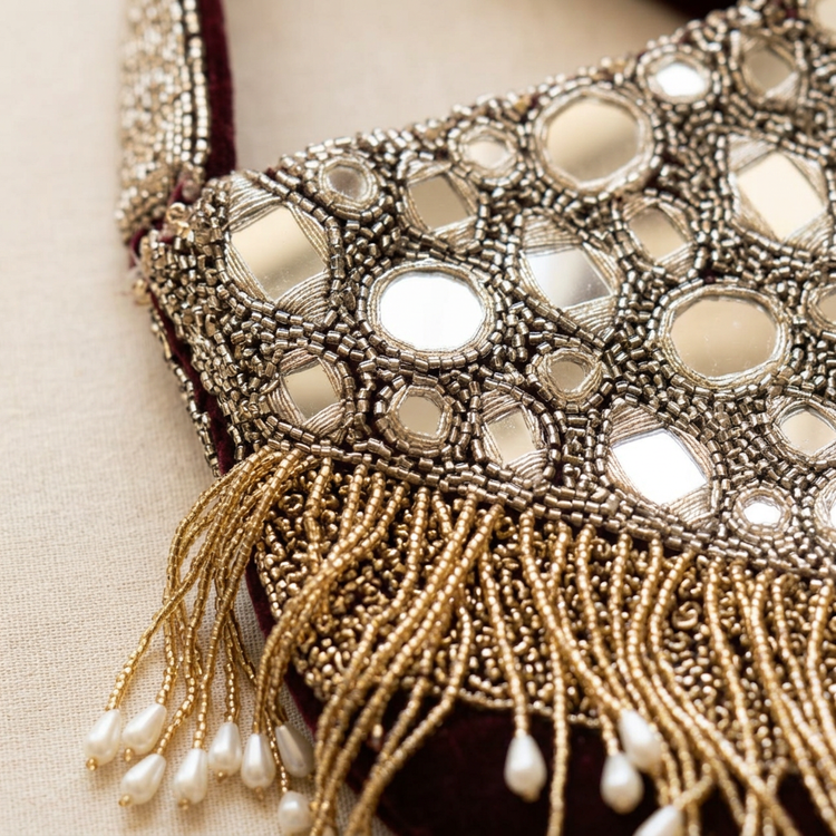 Close-up of mirror embellishments and beaded fringe