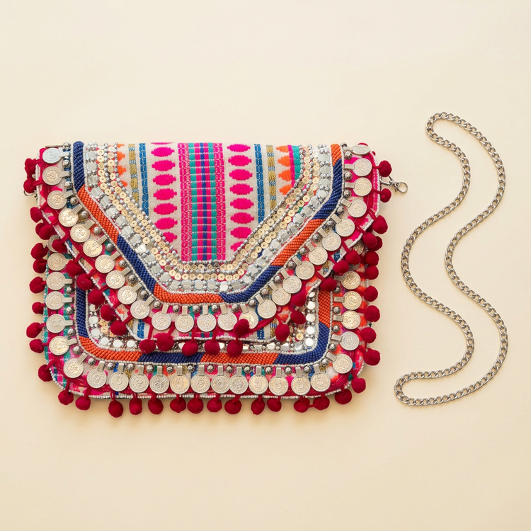 Pink multicolour coin and pom-pom clutch, AI-generated studio image