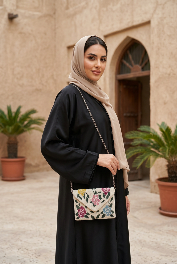 Flora floral bag styled with black abaya