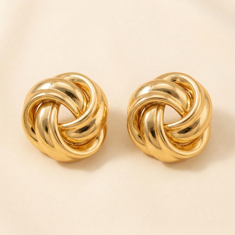 Polished Gold Love Knot Studs studio shot on cream