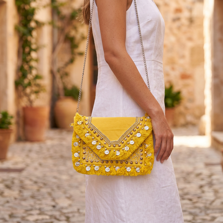 Yellow boho clutch worn with white linen and silver chain, AI-generated lifestyle image