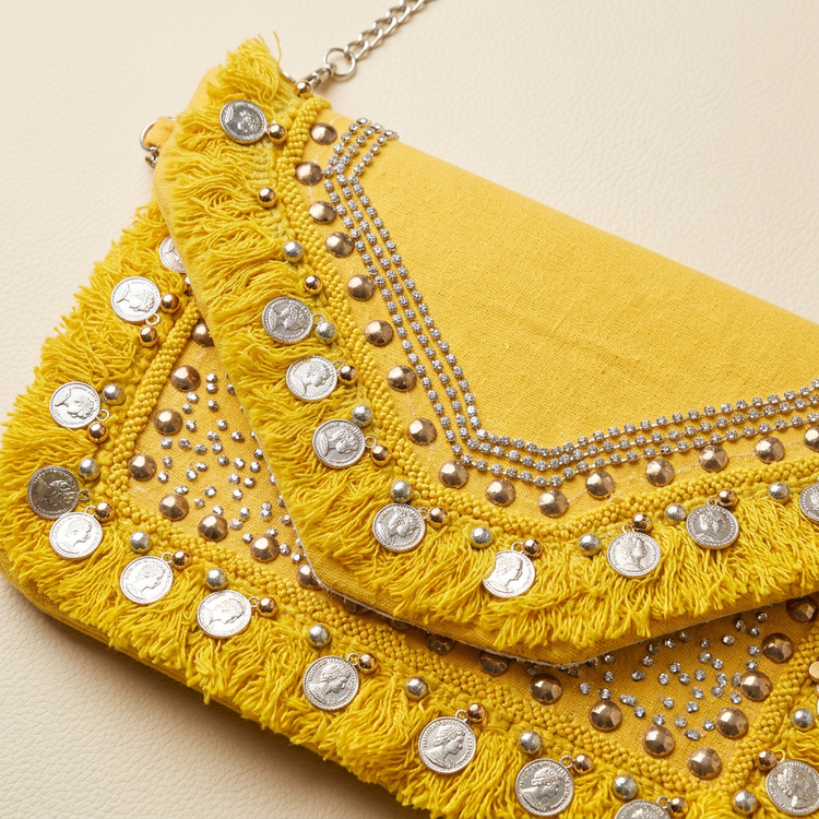 Detail of yellow fringe, coin charms and sparkling embellishments