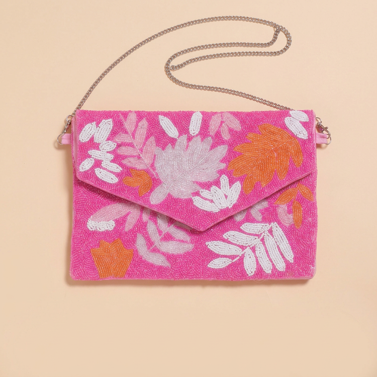 Pink Tropic botanical beaded bag on cream studio background